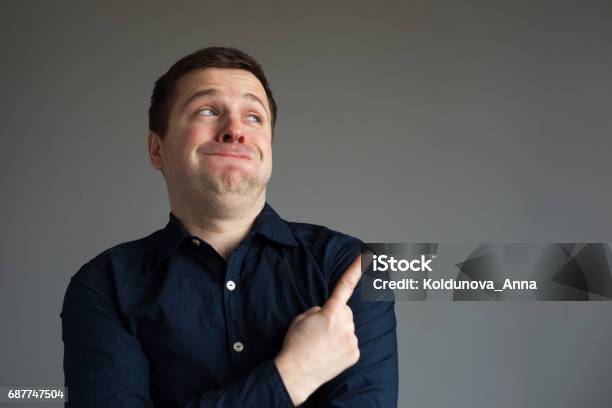 Surprised Man Showing On Important Information Stock Photo - Download Image Now - Laughing, Pointing, Men