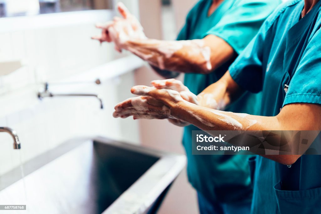 Couple of Surgeons Washing Hands Before Operating. Couple of Surgeons Washing Hands Before Operating. Hospital Concept. Washing Hands Stock Photo