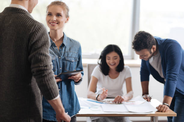 istock Joyful pretty woman looking at her colleague 687758930