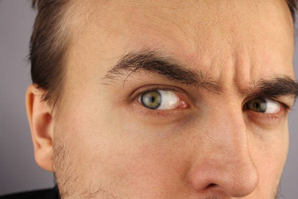 Close-up shot of an angry person's eye in night light