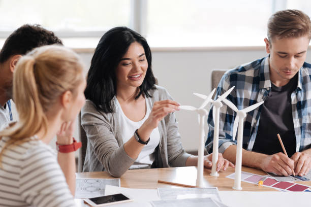 istock Cheerful delighted woman touching the windmill model 687759020