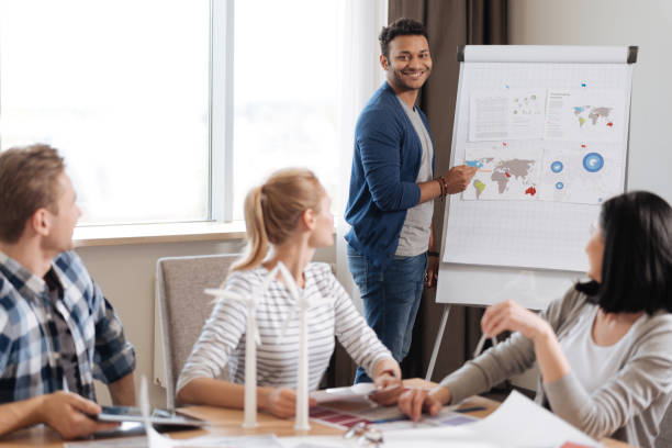 istock Joyful nice man presenting his report to the colleagues 687763986