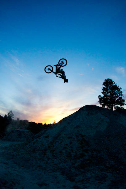 istock A young man does a backflip on his dowhill-style mountain bike at sunset. 687768502