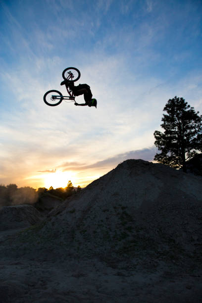 istock A young man does a backflip on his dowhill-style mountain bike at sunset. 687770132