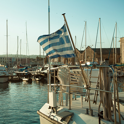 Port, the Greek flag and boats. Impressions of Greece