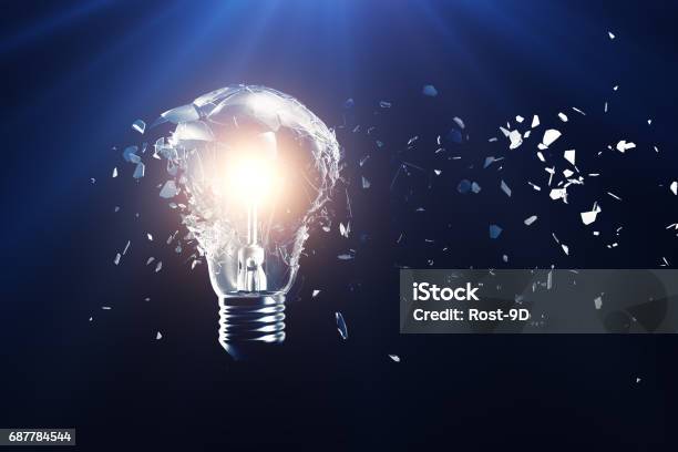 Exploding Light Bulb On A Blue Background With Concept Creative Thinking And Innovative Solutions 3d Rendering Stock Photo - Download Image Now