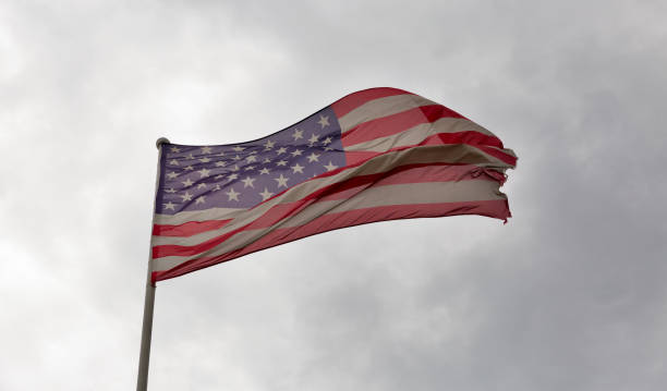 istock American flag waving against a cloudy sky 687787350