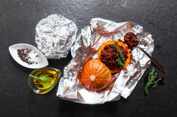 istock Stew in foil. Pumpkin and ingredients. On a dark stone background 687791028