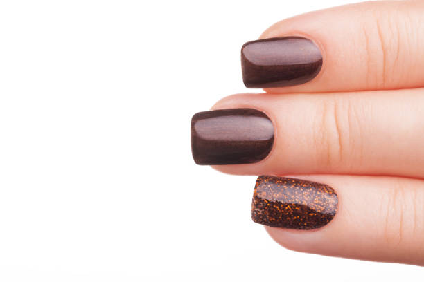 istock Brown nail polish on the nails. 687797860