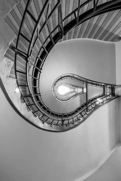 istock Abstract shot of a staircase leading towards a light bulb like opening 687802748