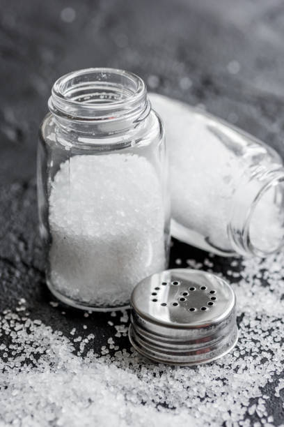 istock Cooking set with salt in glass bottle on dark background 687802750