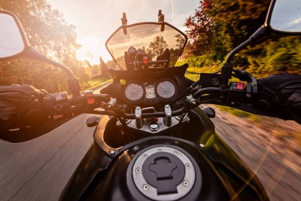 istock Man driving his motorcycle on asphalt country road 687802926