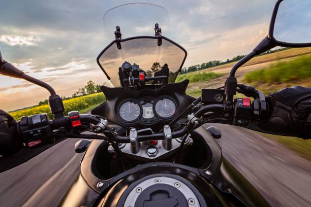 istock Man driving his motorcycle on asphalt country road 687803034