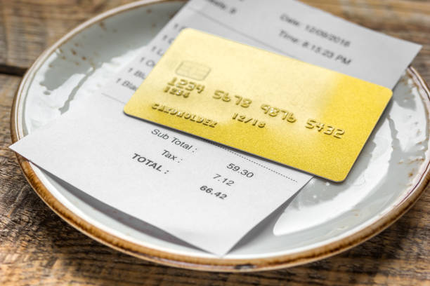 istock credit card for paying, plate, glasses and check on cafe desk background 687803108