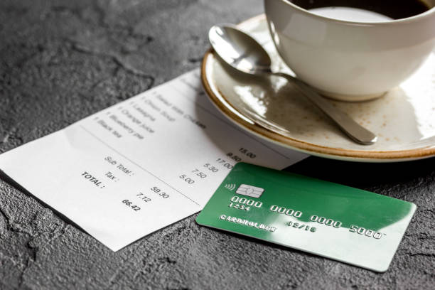 istock restaurant bill, card and coffee on dark table background 687803142