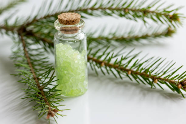 istock cosmetic spruce salt in bottles with fur branches on white table background 687807834