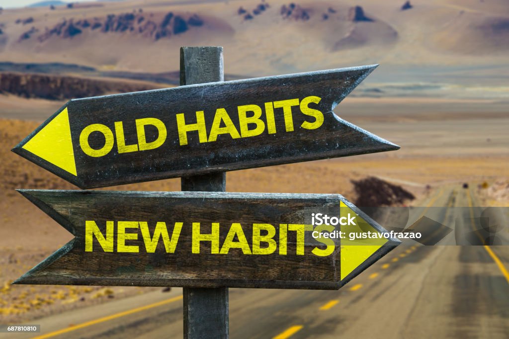 Old Habits - New Habits signpost Old Habits - New Habits signpost in a desert road background Addiction Stock Photo