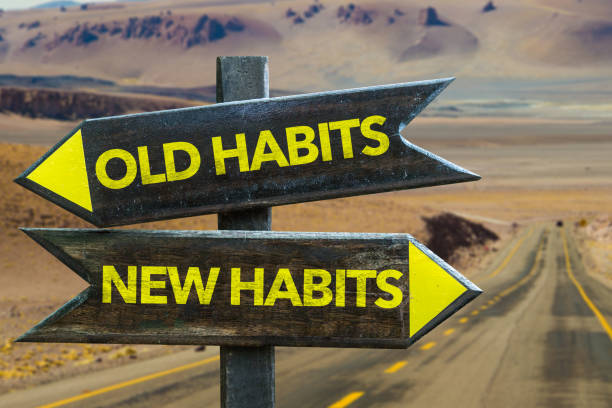 Old Habits - New Habits signpost Old Habits - New Habits signpost in a desert road background Routine stock pictures, royalty-free photos & images