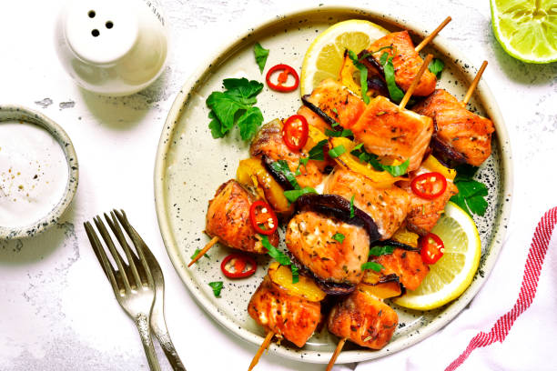istock Grilled salmon kebab on a craft plate. 687813360