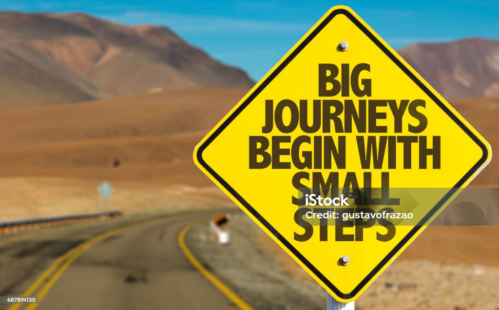 Big Journeys Begin With Small Steps sign with sky background Big Journeys Begin With Small Steps sign Journey Stock Photo