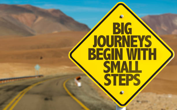 big journeys begin with small steps sign with sky background - restarting imagens e fotografias de stock