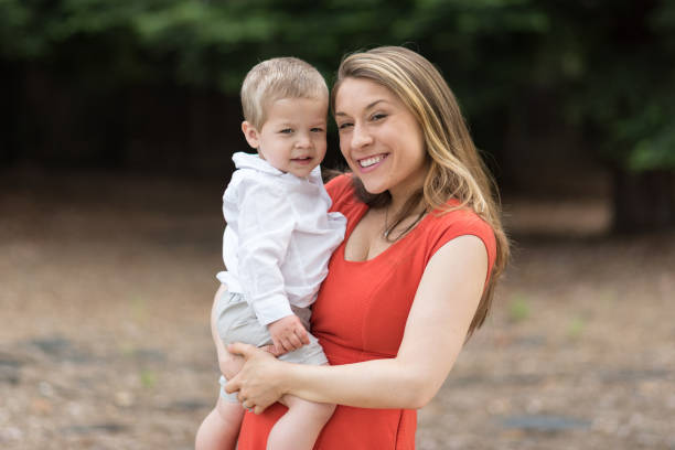Cute Millennial Mom Holding Toddler Son stock photo