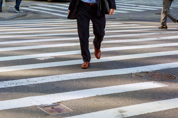 istock business man walks on a pedestrian crossing 687820400
