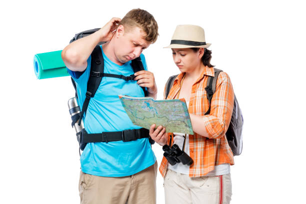 istock Frustrated lost tourists with map isolated on white background 687828566