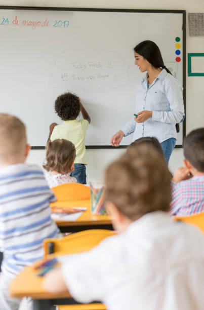 istock African American boy writing on the board in class at the school 687830486