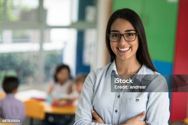 Portrait Of A Happy Latin American Teacher At The School Stock Photo - Download Image Now