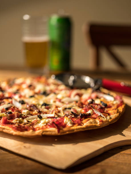 istock Homemade Pizza on wooden table with Beer 687832018