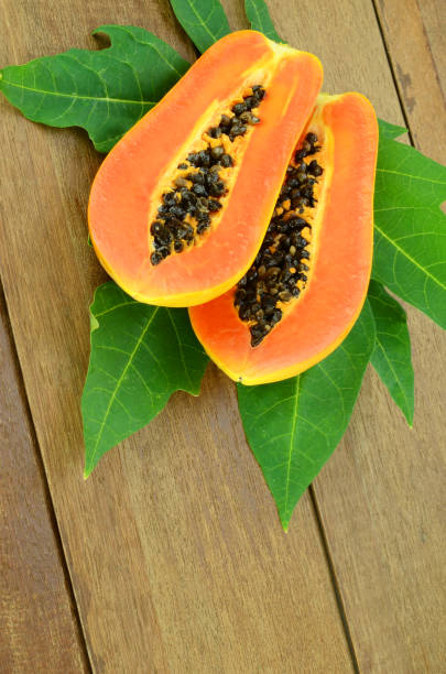 istock Ripe papaya on wood background. 687832184