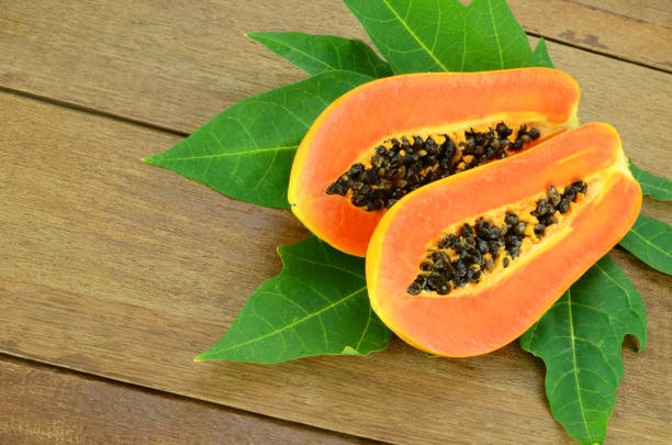 istock Ripe papaya on wood background. 687832210