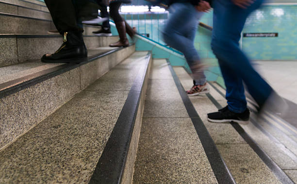 istock Low Section Of People On Staircase At Railroad Station 687840739