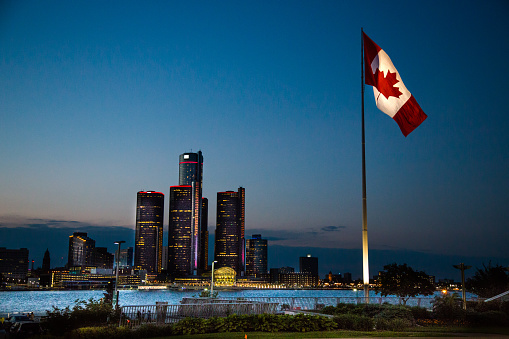 Canada national flag waving on sunset sky. Canada day. 3d-rendering.