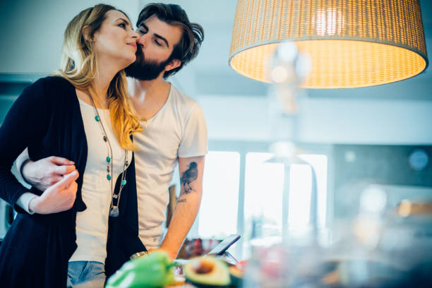 istock Beautiful couple having good time while cooking in the kitchen 687849824