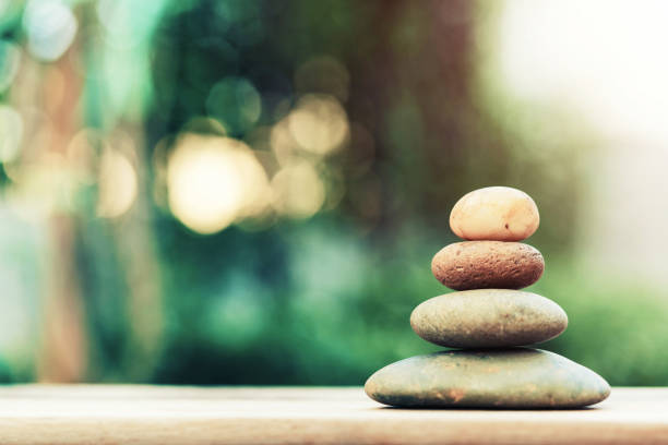 istock Stack of zen stones on ground with blurred nature background. 687850352