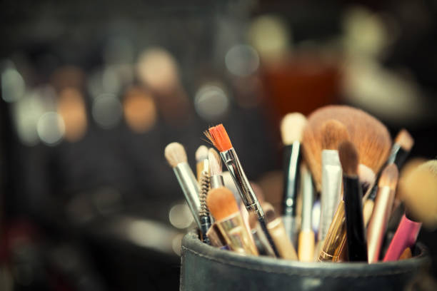 istock Close-up of make up table with professional makeup brush. Visagiste tools.Different brushes for cosmetics. Beauty make-up background concept. Vintage filtered. 687850366