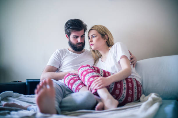 Young couple in the bed in the morning Young couple in the bed in the morning infertility stock pictures, royalty-free photos & images