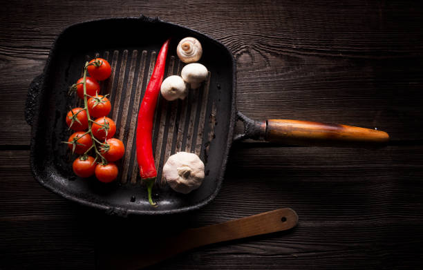 Cast iron fry pan on wooden background