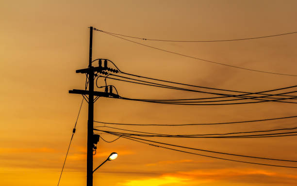 istock Electricity pylons evening with sun. 687861058