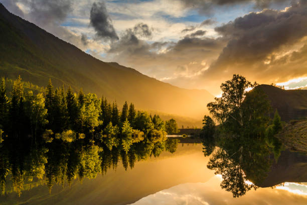 istock Reflection of misty mountains at sunset 687868850
