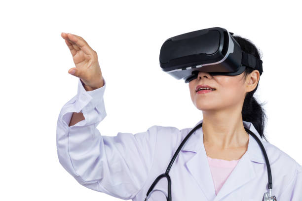 istock Asian female doctor touching screen by virtual reality goggles 687870672