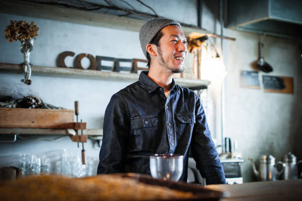 istock confident young male happy cafe owner 687875154
