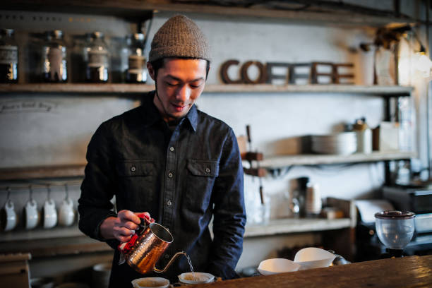 istock confident young male happy cafe owner 687875240