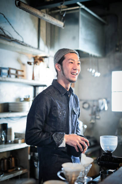 istock confident young male happy cafe owner 687875426