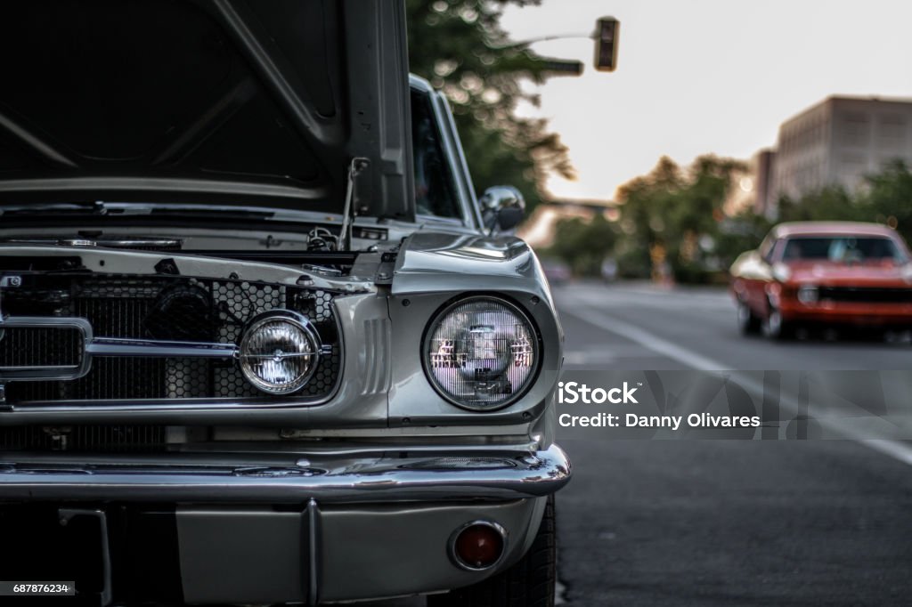 When Cars Were Classic Cars Parked, Cars Driving, Man Sitting on Car American Culture Stock Photo