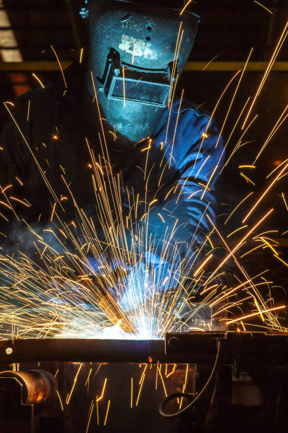 istock Worker welding the steel part by manua 687876250