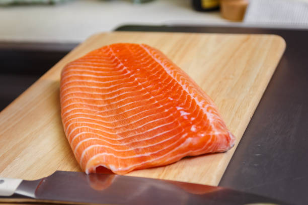 Rainbow Trout fillet Fillet of rainbow trout in kitchen on clean chopping board fresh cilantro stock pictures, royalty-free photos & images