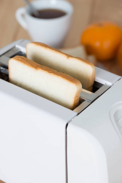 istock Close up, Bread in toaster with coffee. 687881178
